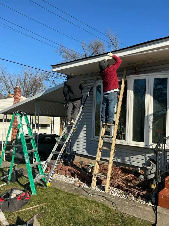 Restoration crew performing exterior repair in Bedford